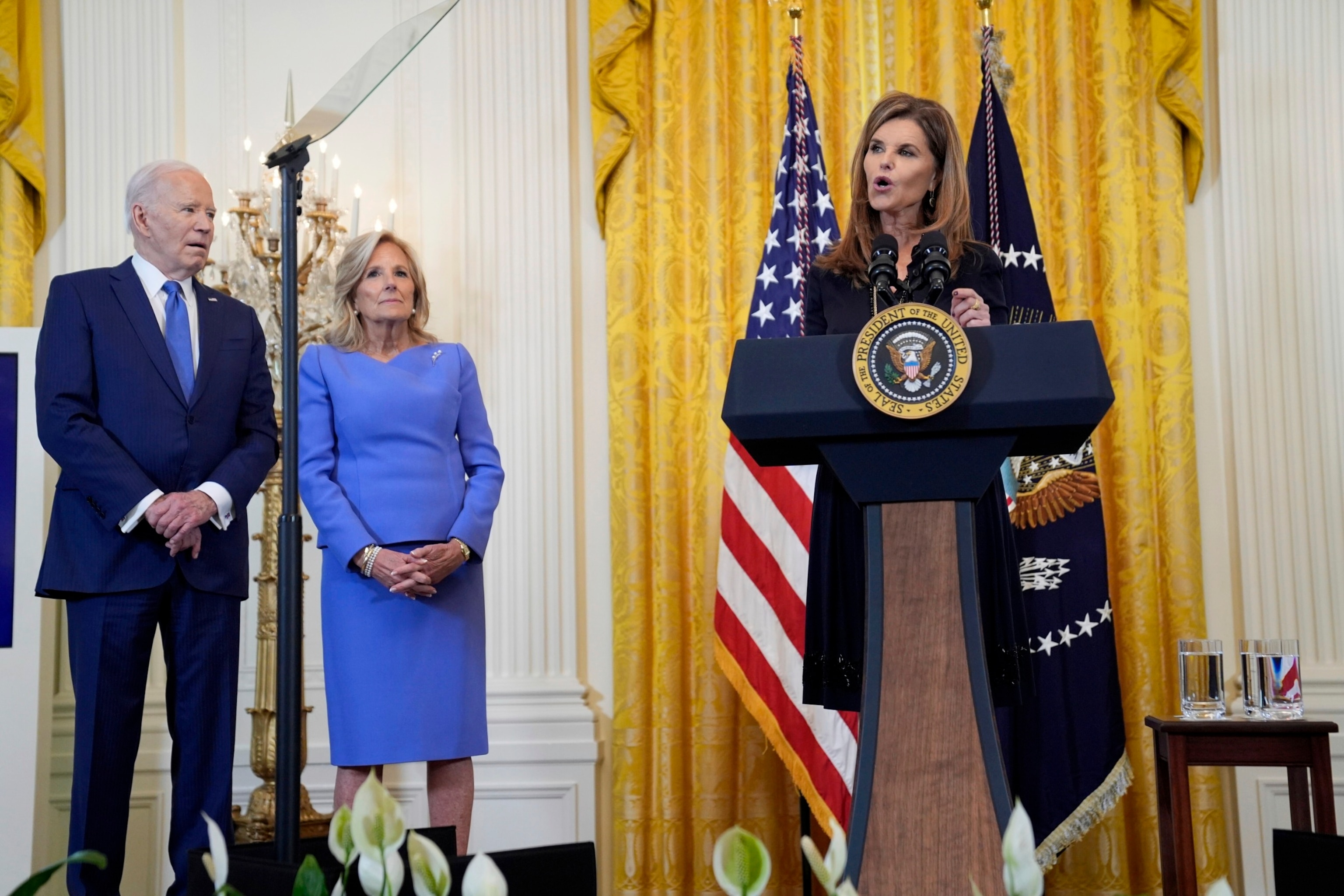 PHOTO: Maria Shriver speaks during a Women's History Month reception in the East Room of the White House, March 18, 2024, in Washington, as President Joe Biden and first lady Jill Biden look on.